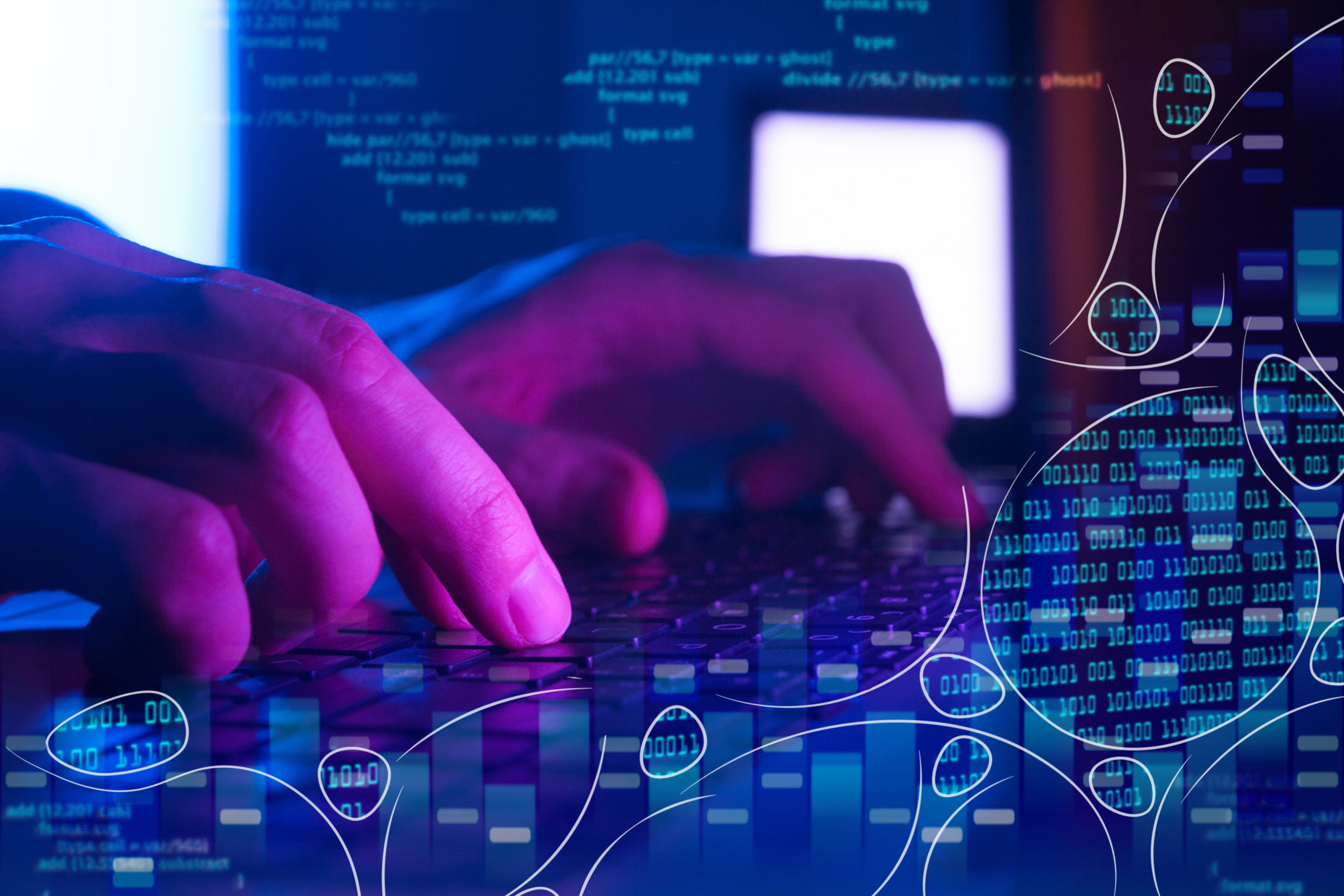 An IT professional's hands typing on a laptop.